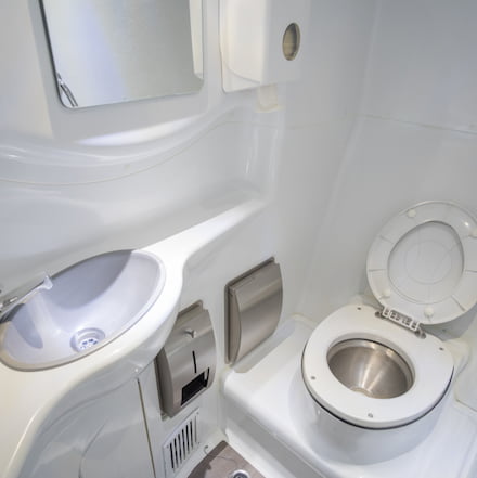 the interior of a small bathroom on a charter bus